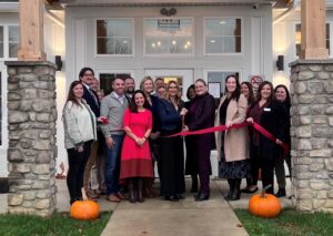 Employees posing for ribbon cutting celebration